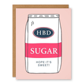 HBD Sugar – Hope It’s Sweet Birthday Card showing a pink-and-white sugar bag illustration with sweet birthday wording with front cover text: HBD Sugar. Hope it’s sweet!