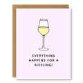 Everything Happens for a Riesling Card showing a simple wine glass filled with white wine on a pale pink background with front cover text: Everything happens for a Riesling!