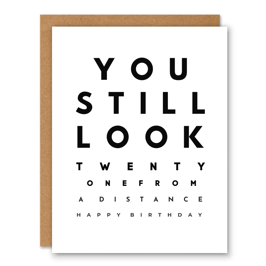 You Still Look 21 Birthday Card showing bold eye-chart-style typography with a small red heart with front cover text: You still look twenty one from a distance. Happy birthday