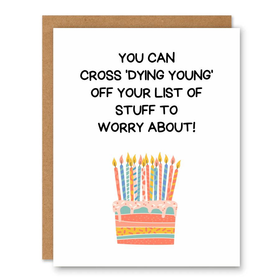 Cross ‘Dying Young’ Off Your List Birthday Card showing a birthday cake with candles and darkly funny aging text with front cover text: You can cross ‘dying young’ off your list of stuff to worry about!