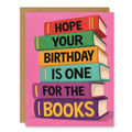 One for the Books Greeting Card showing a bright stack of books with bold birthday lettering on a pink background with front cover text: I hope your birthday is one for the books
