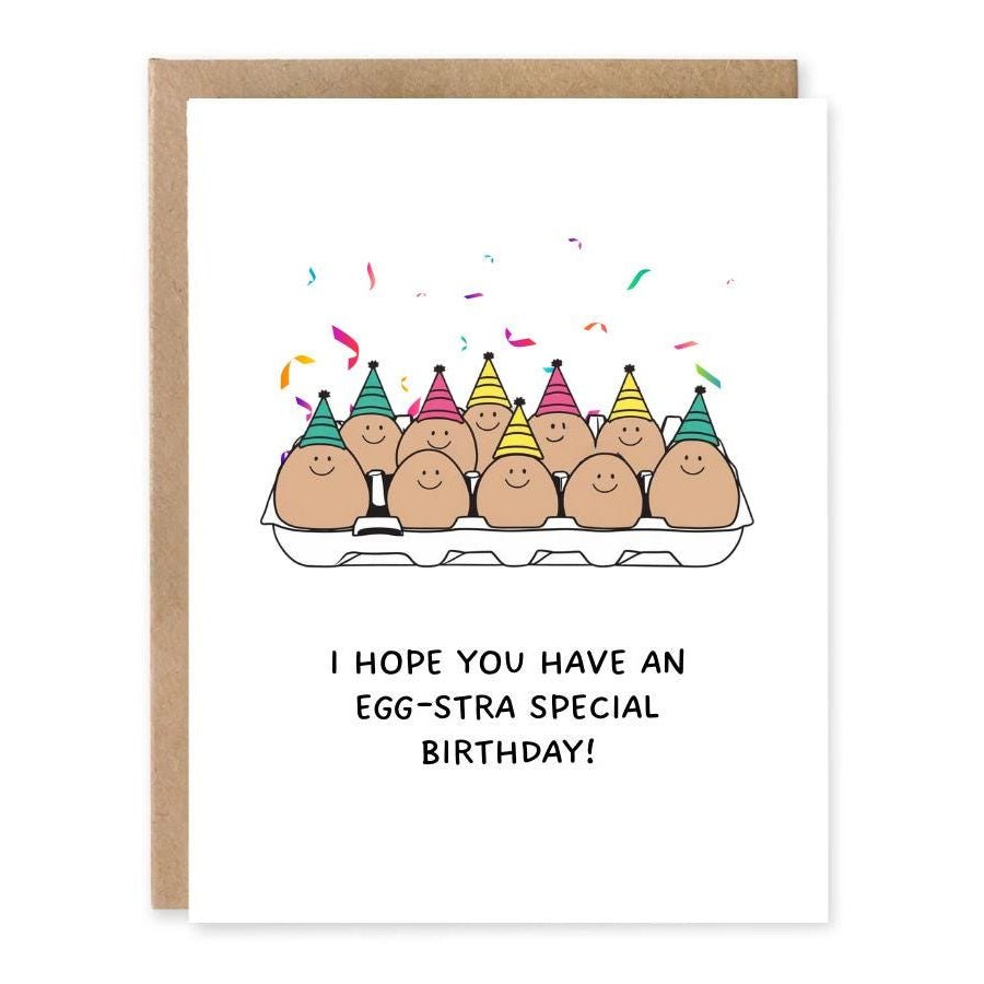 Pun Egg Birthday Card - Funny Greeting Card For Him showing a carton of smiling eggs in party hats with confetti with front cover text: I hope you have an egg-stra special birthday!