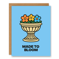 Made to Bloom Card showing a classical flower urn filled with cheerful blooms in a colourful retro-inspired style with front cover text: Made to bloom