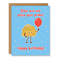 Not Pasta Prime Birthday Card showing a cute smiling pile of pasta holding a red balloon with front cover text: Older but not yet pasta your prime. Happy birthday!